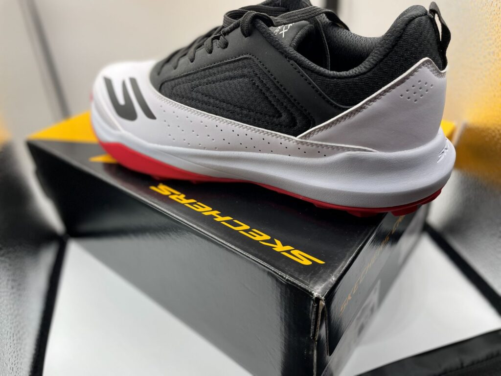 Skechers turf cricket shoes in black, white, and red on shoe box